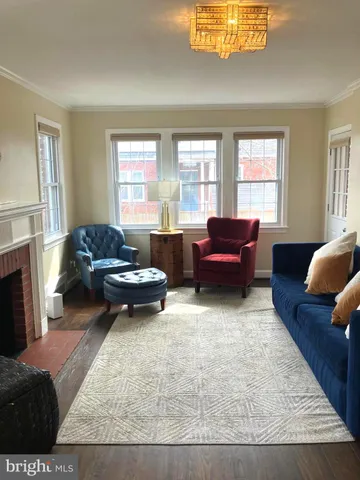 a living room with furniture rug and window