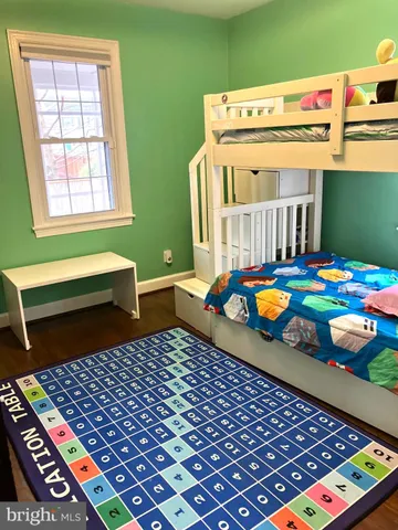 a bedroom with bunk bed and a window