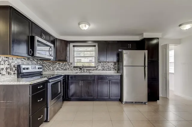 a kitchen with a refrigerator and a sink