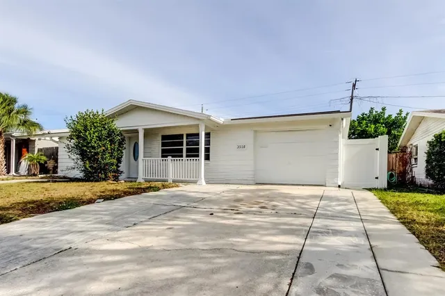 a front view of a house with a yard and a garage