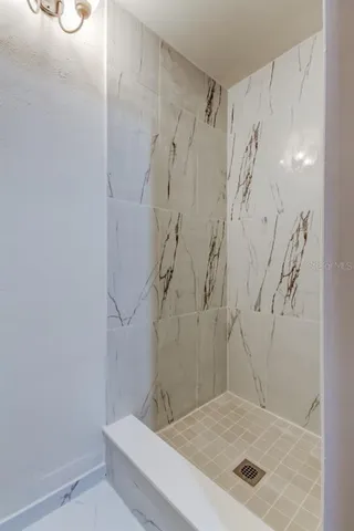 a bathroom with a shower and a sink