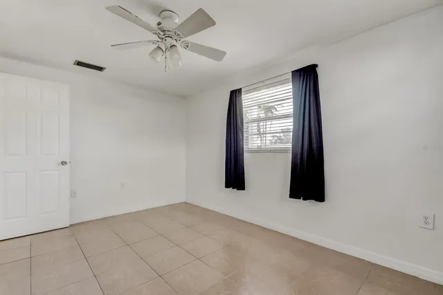a view of a livingroom with a ceiling fan and window