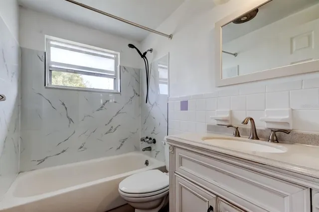a bathroom with a sink a toilet and a bathtub