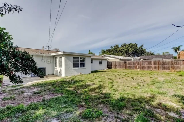 a view of a house with a yard and a garage