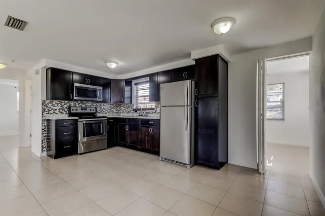 a kitchen with stainless steel appliances a refrigerator and a stove