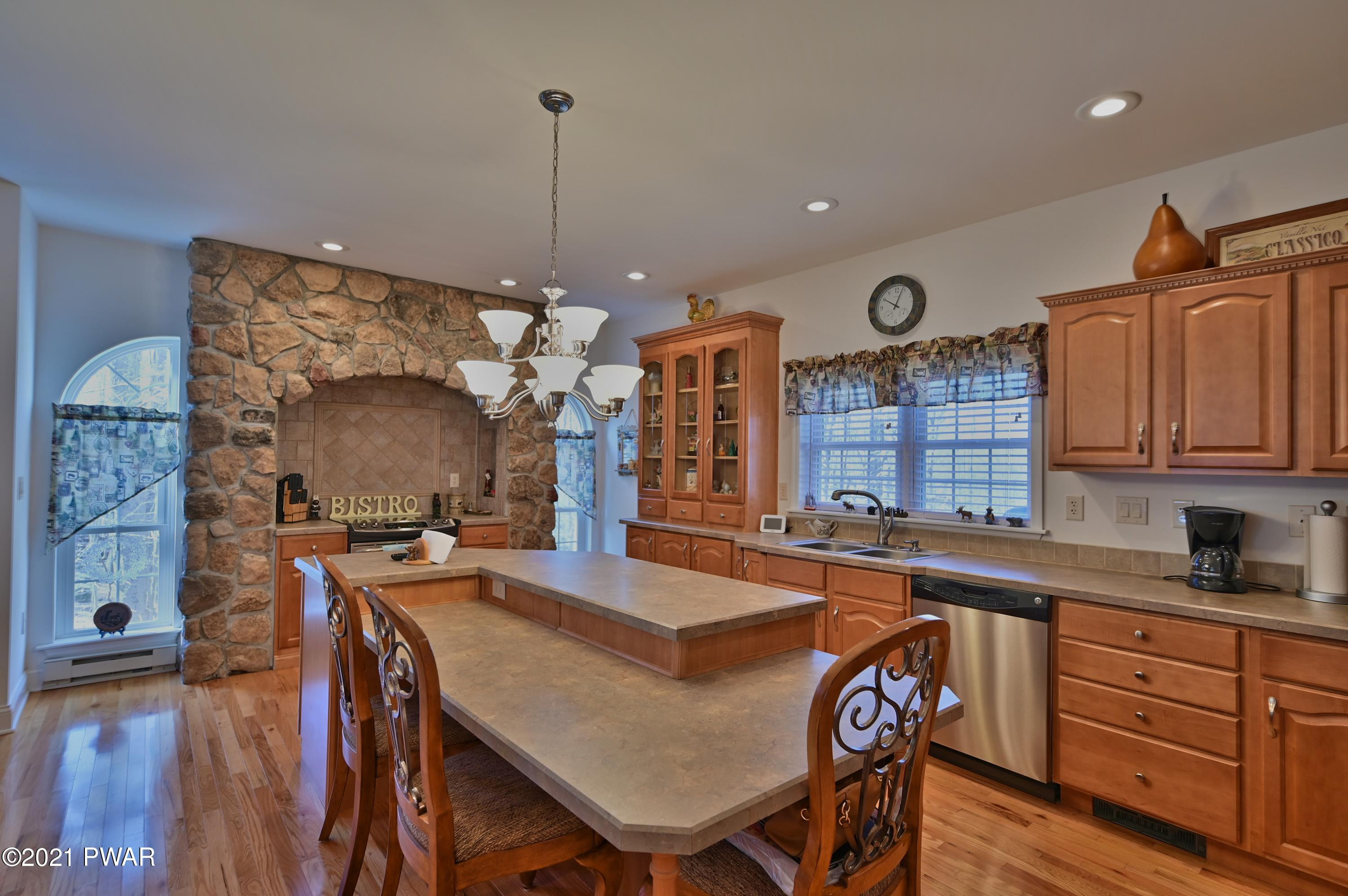 467 Northgate Road Lake Ariel, PA 18436 - Photo 6 of 46 a kitchen with granite countertop a sink a stove and chairs