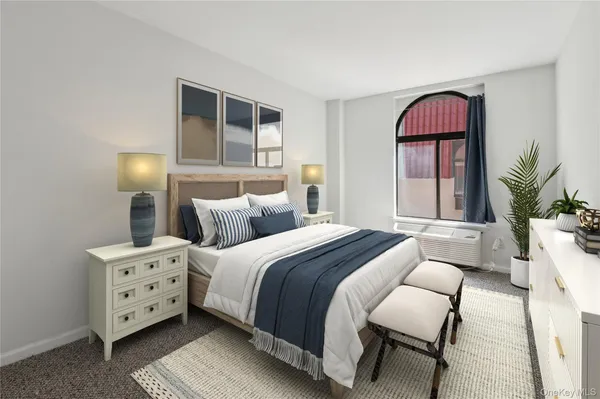 a spacious bedroom with a bed and a window