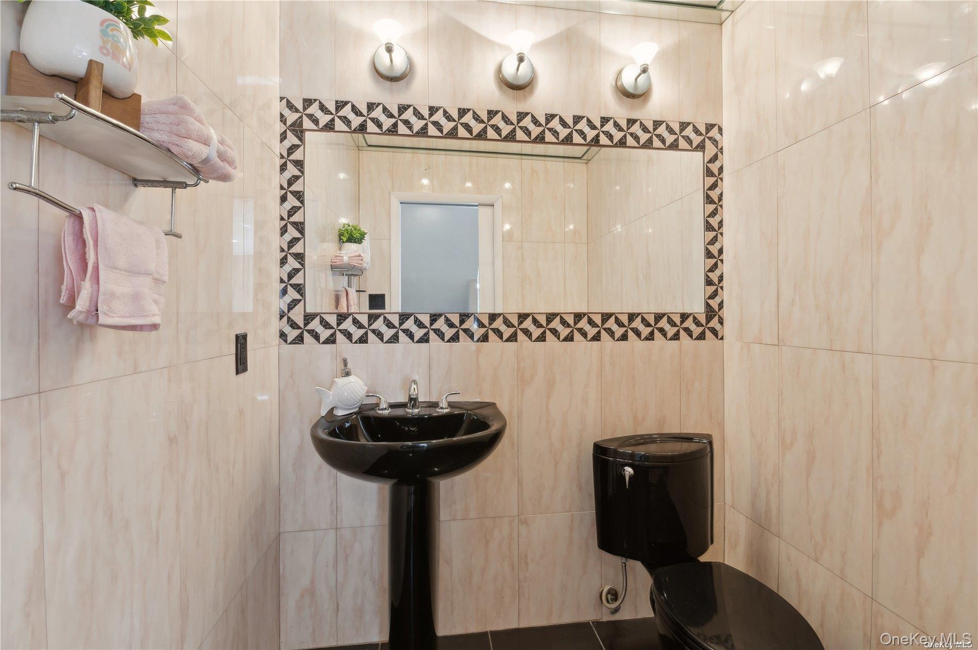 425 Shore Road, Unit 2B Long Beach, NY 11561 - Photo 15 of 23 a bathroom with a sink a mirror and a shower