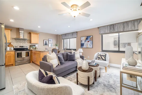 a living room with furniture and kitchen view
