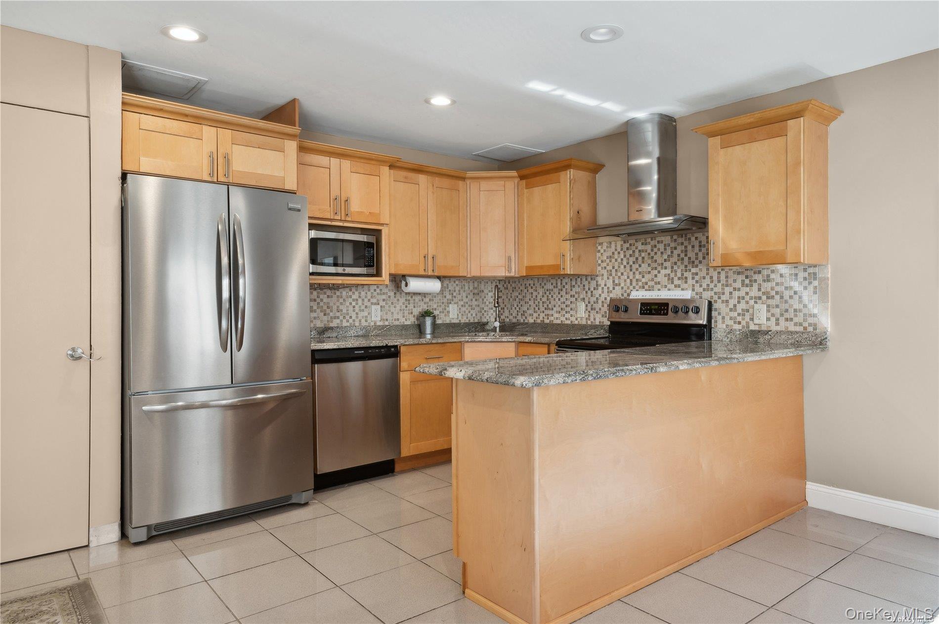 425 Shore Road, Unit 2B Long Beach, NY 11561 - Photo 9 of 23 a kitchen with stainless steel appliances granite countertop a refrigerator a stove a sink and a refrigerator