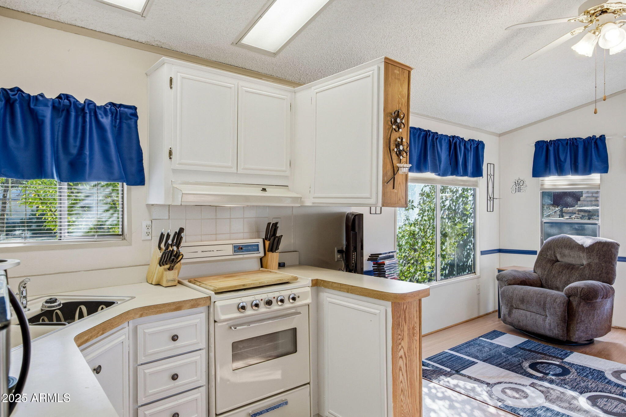 2169 Tenderfoot Trail Overgaard, AZ 85933 - Photo 11 of 30 a kitchen with a stove a sink and a refrigerator