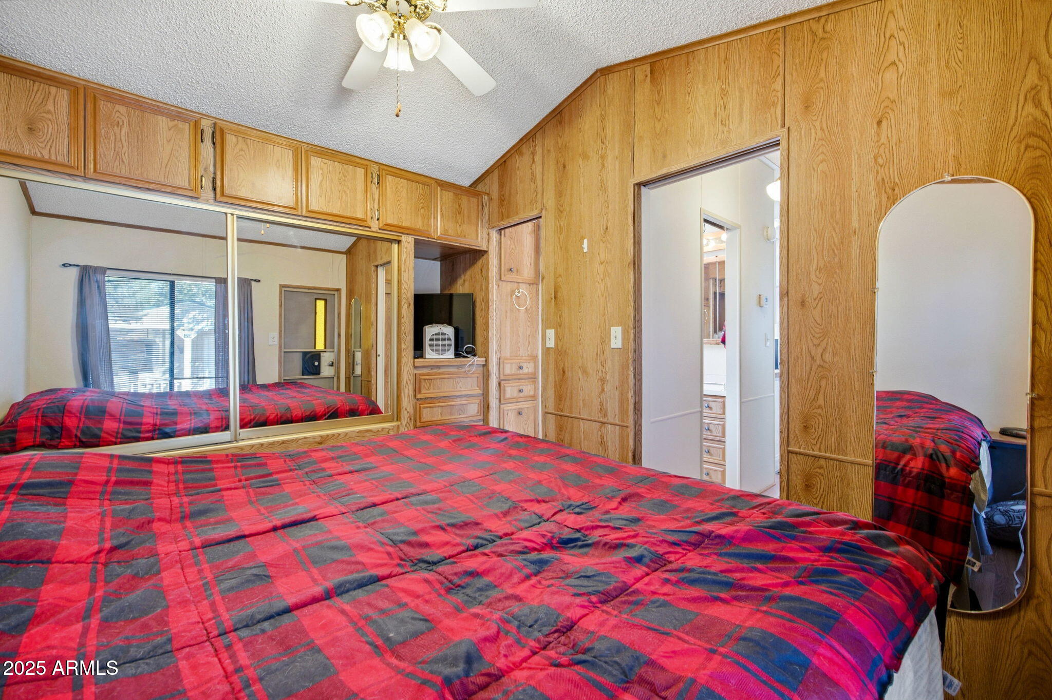 2169 Tenderfoot Trail Overgaard, AZ 85933 - Photo 14 of 30 a bedroom with a bed and a chandelier
