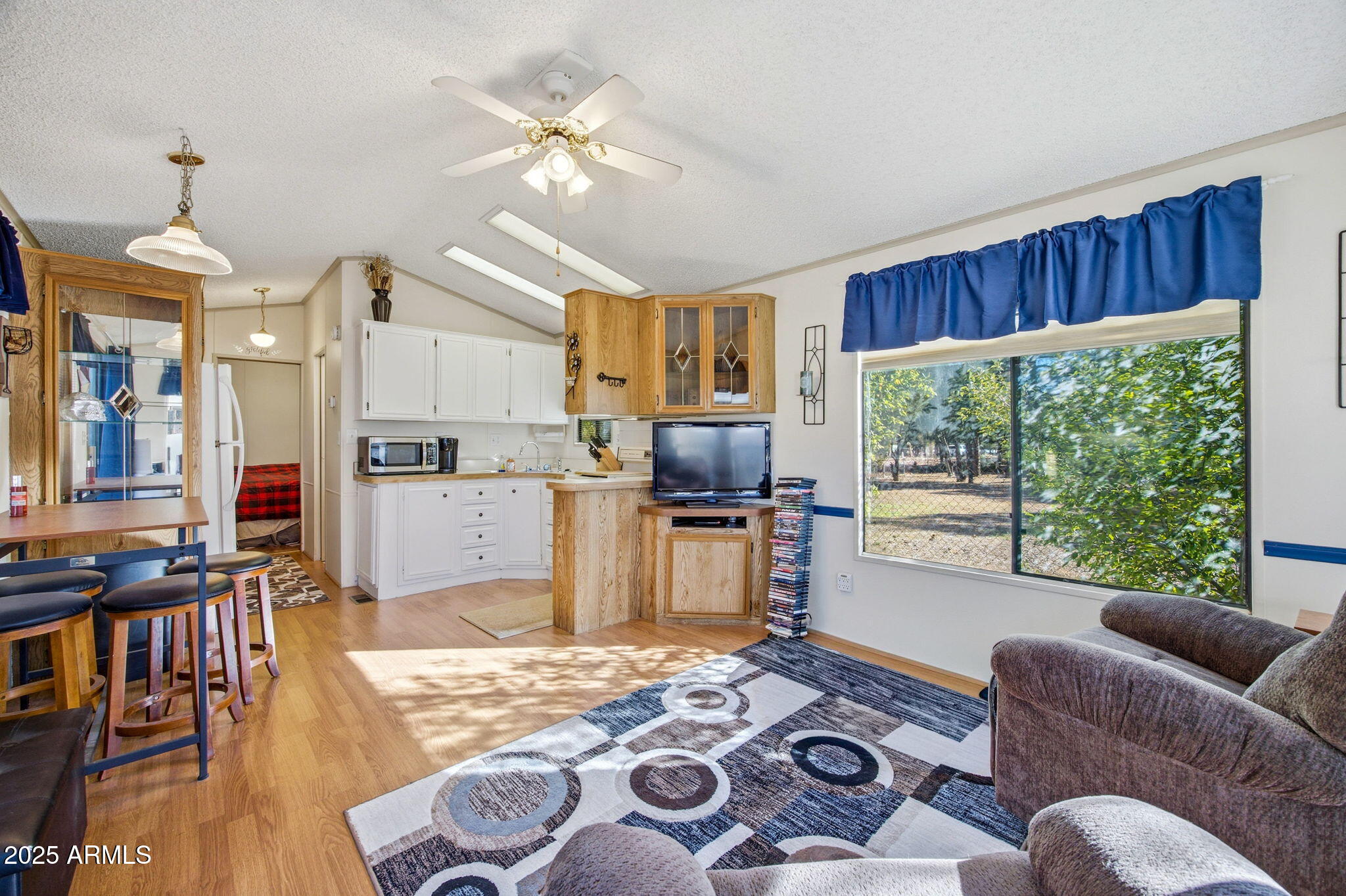 2169 Tenderfoot Trail Overgaard, AZ 85933 - Photo 8 of 30 a living room with kitchen island furniture and a open kitchen view