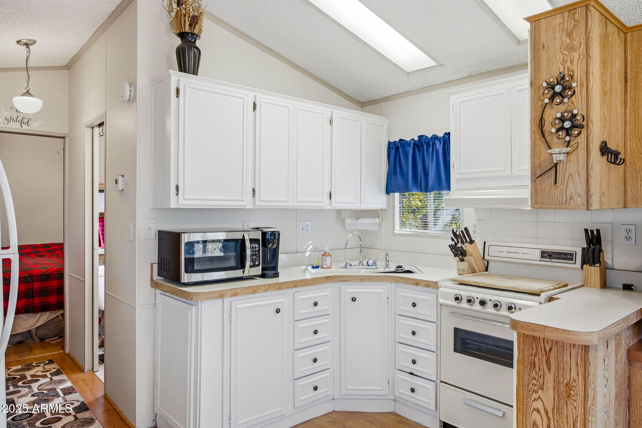 2169 Tenderfoot Trail Overgaard, AZ 85933 - Photo 10 of 30 a kitchen with white cabinets and white appliances