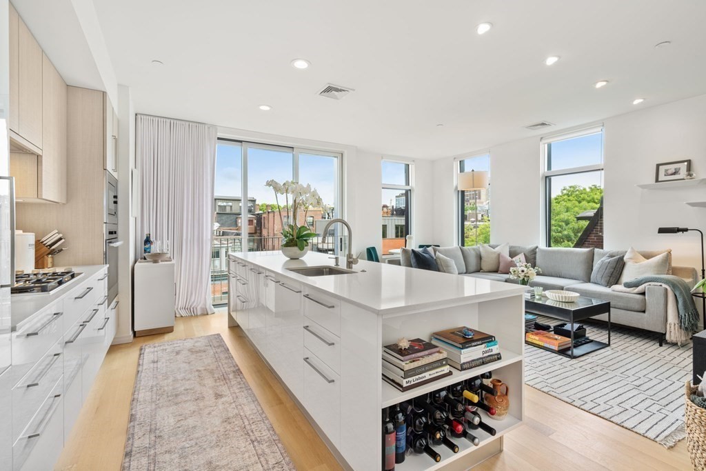 7 East Springfield Street, Unit 5B Boston, MA 02118 - Photo 3 of 19 a large kitchen with stainless steel appliances kitchen island granite countertop a sink and cabinets