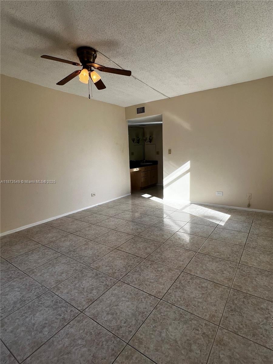 3760 Inverrary Drive, Unit 2Z Lauderhill, FL 33319 - Photo 15 of 34 an empty room with a ceiling fan and a window
