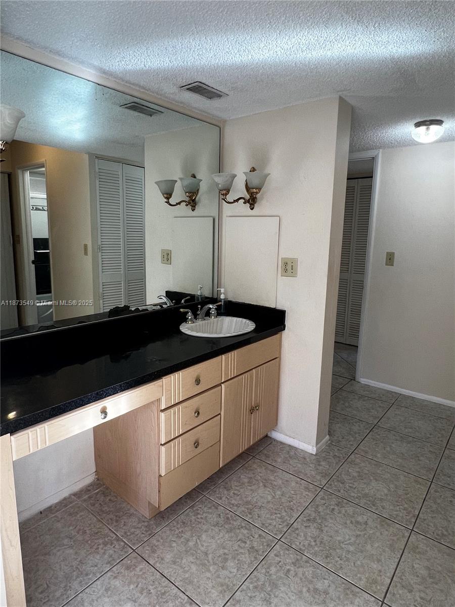 3760 Inverrary Drive, Unit 2Z Lauderhill, FL 33319 - Photo 16 of 34 a bathroom with a sink and a mirror
