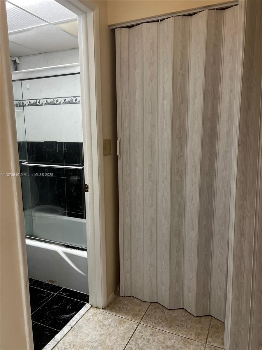 3760 Inverrary Drive, Unit 2Z Lauderhill, FL 33319 - Photo 18 of 34 a bathroom with a glass door