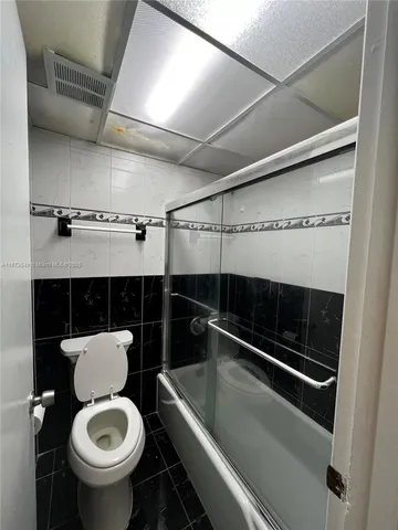 a view of a hallway to rooms and stairs