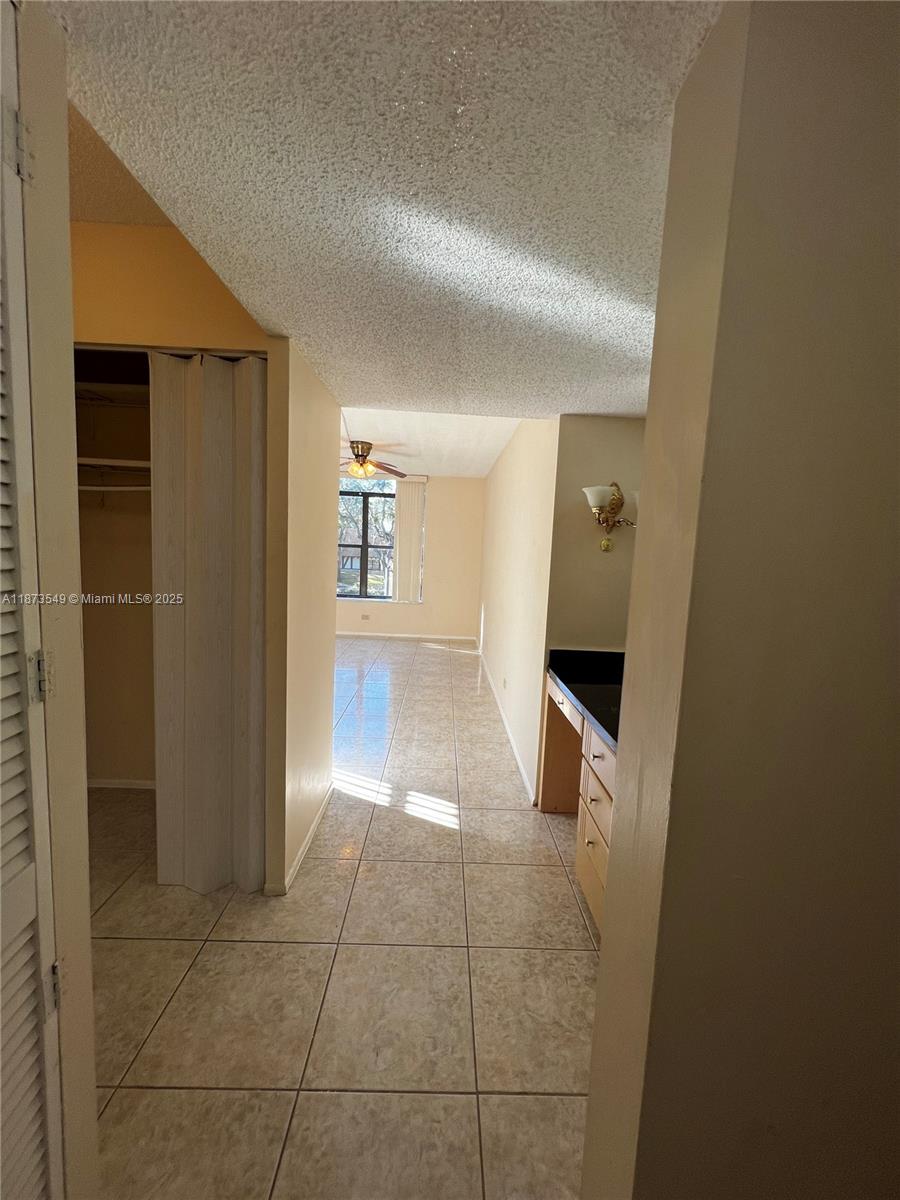 3760 Inverrary Drive, Unit 2Z Lauderhill, FL 33319 - Photo 21 of 34 a view of a hallway to rooms and stairs
