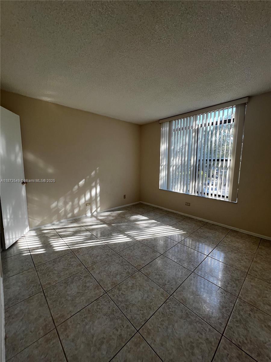 3760 Inverrary Drive, Unit 2Z Lauderhill, FL 33319 - Photo 22 of 34 a view of an empty room with a fireplace