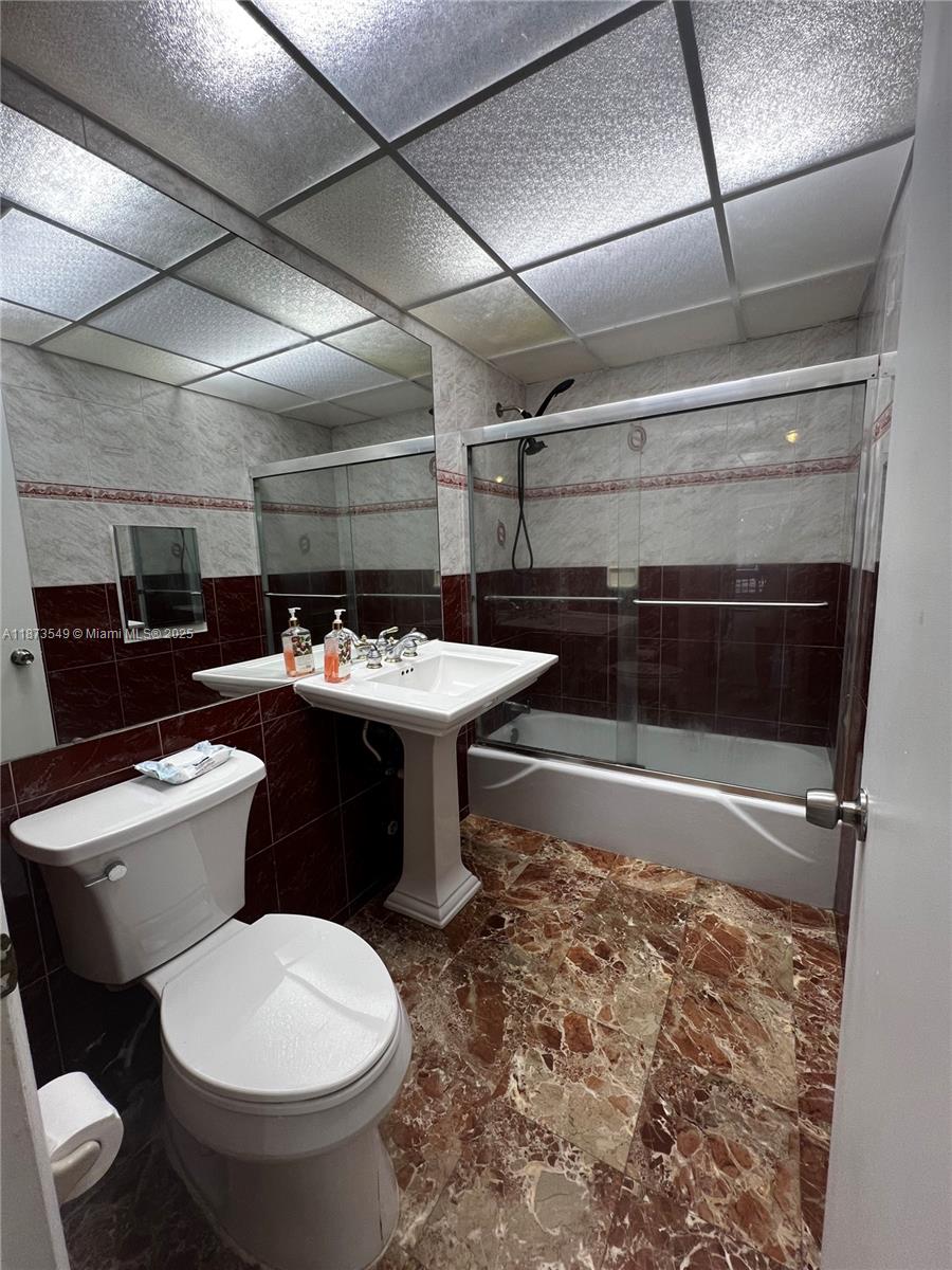 3760 Inverrary Drive, Unit 2Z Lauderhill, FL 33319 - Photo 27 of 34 a bathroom with a sink toilet and shower