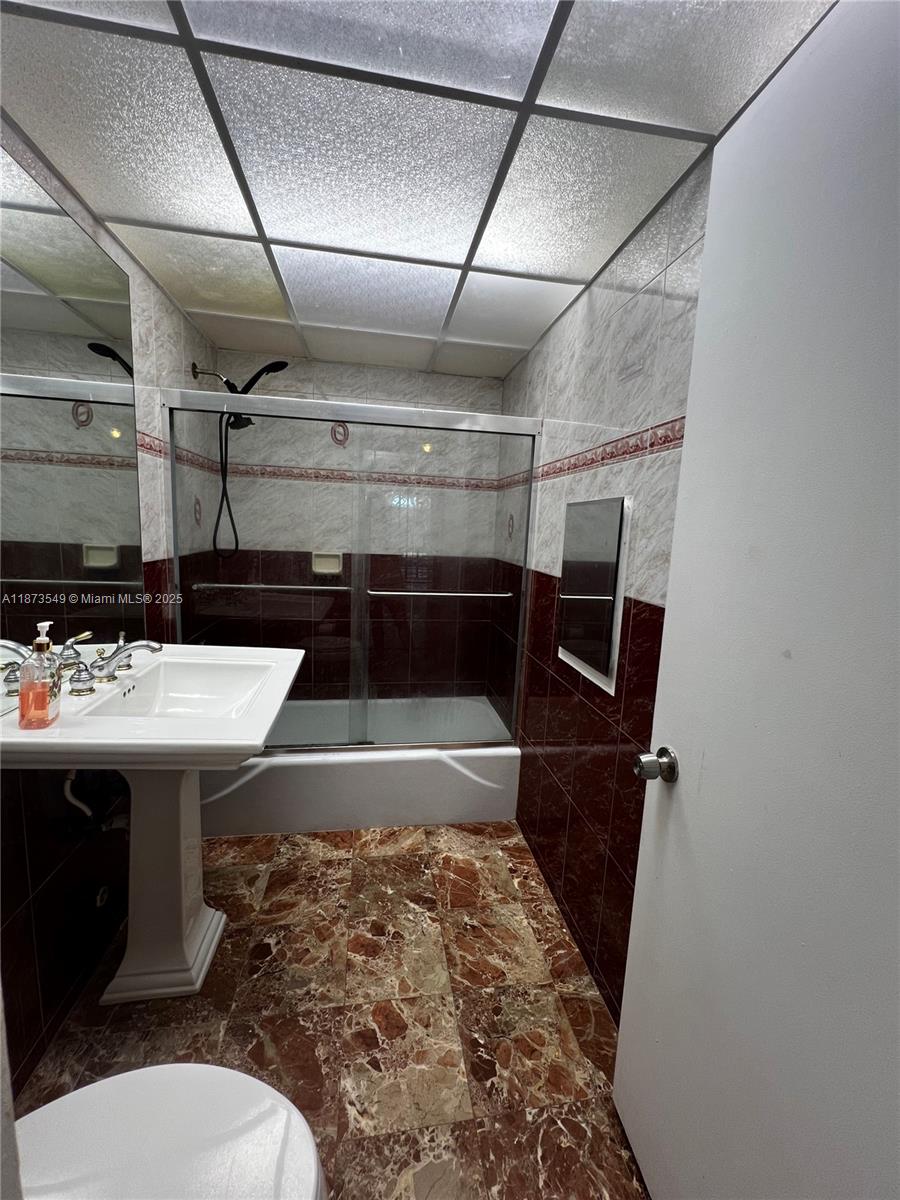 3760 Inverrary Drive, Unit 2Z Lauderhill, FL 33319 - Photo 28 of 34 a bathroom with a sink and a toilet