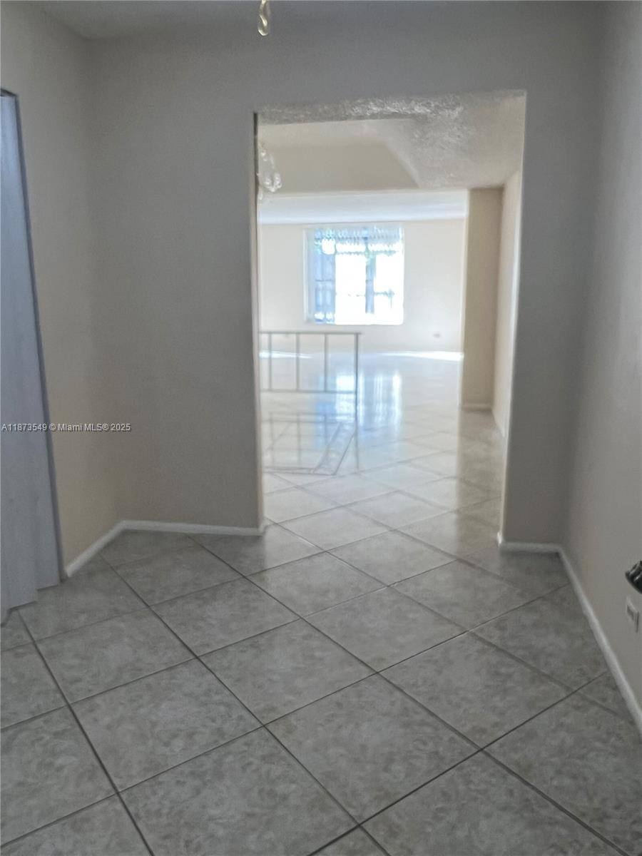 3760 Inverrary Drive, Unit 2Z Lauderhill, FL 33319 - Photo 34 of 34 an empty room with windows and way to kitchen