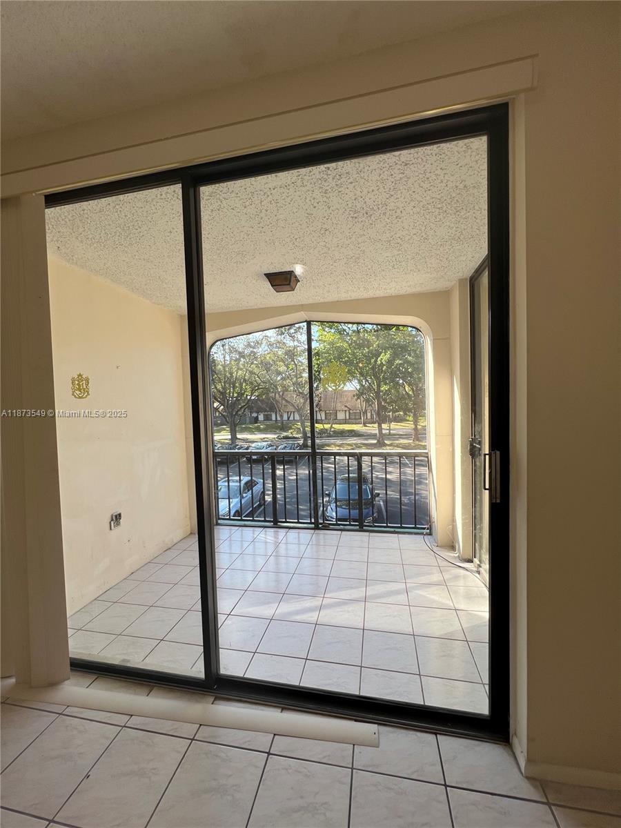 3760 Inverrary Drive, Unit 2Z Lauderhill, FL 33319 - Photo 5 of 34 a view of a glass door with a porch