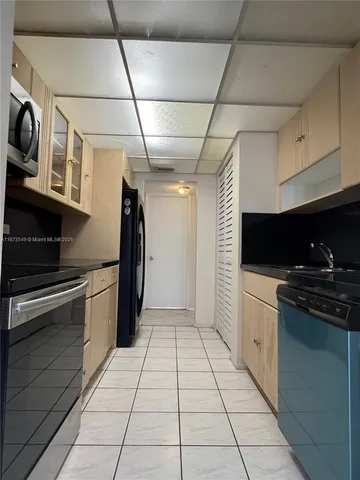 a kitchen with stainless steel appliances granite countertop a stove and a refrigerator