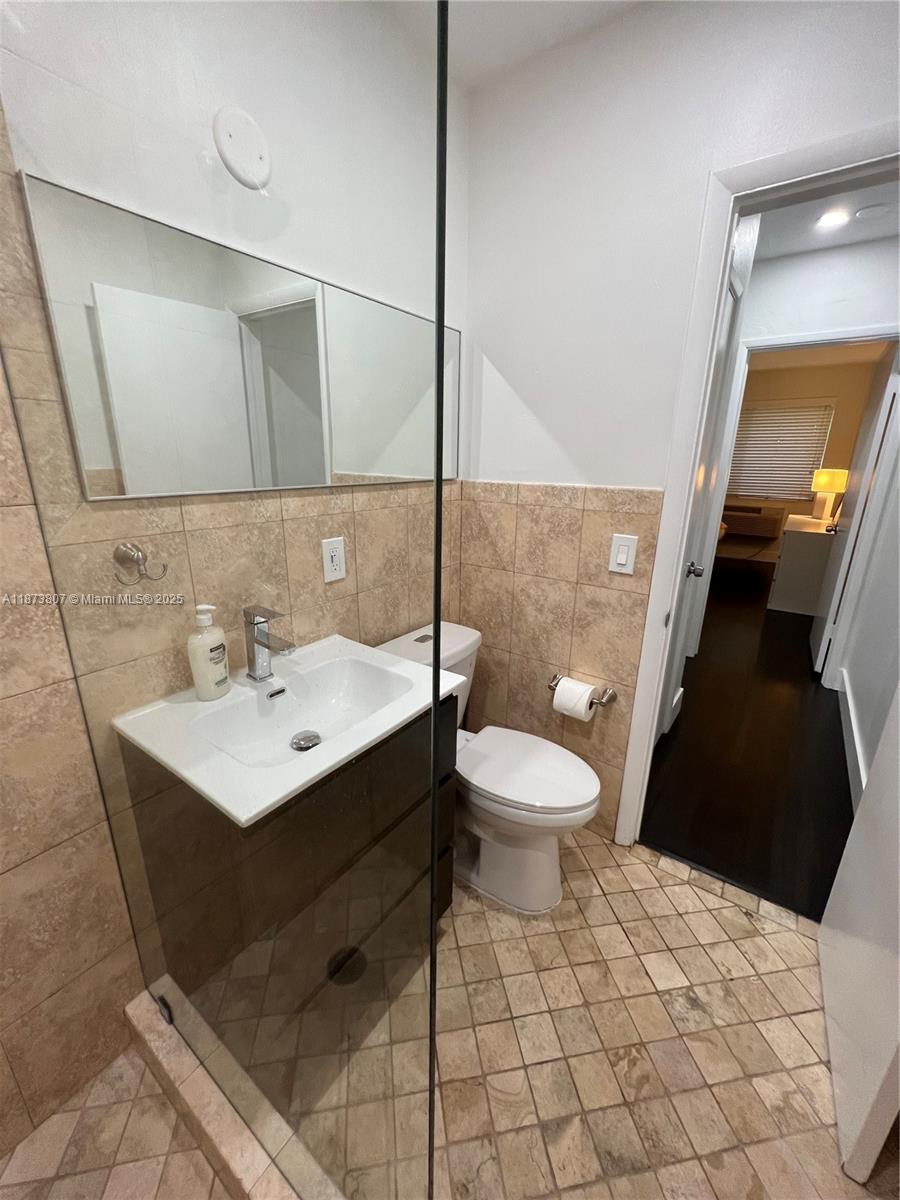 620 Jefferson Avenue, Unit 2 Miami Beach, FL 33139 - Photo 15 of 24 a bathroom with a sink toilet and mirror