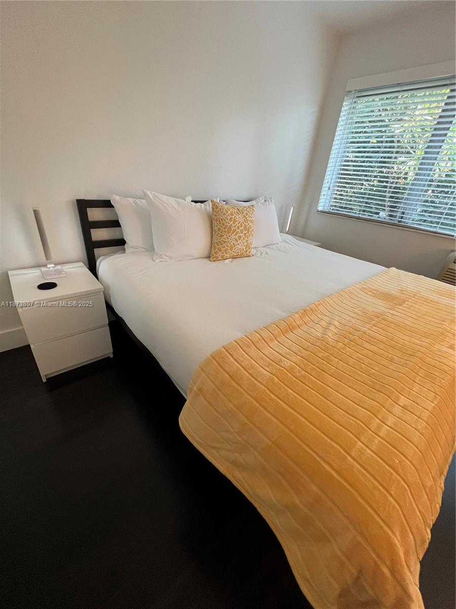 620 Jefferson Avenue, Unit 2 Miami Beach, FL 33139 - Photo 19 of 24 a bedroom with a bed and wooden floor