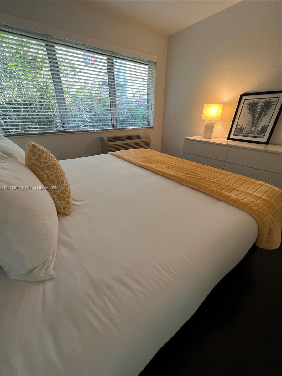 620 Jefferson Avenue, Unit 2 Miami Beach, FL 33139 - Photo 20 of 24 a bed sitting in a bedroom next to a window