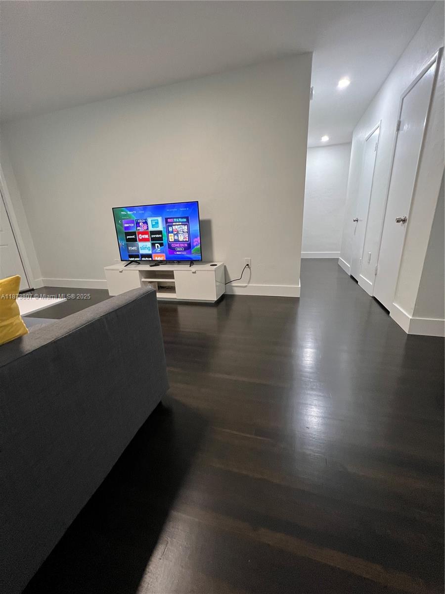 620 Jefferson Avenue, Unit 2 Miami Beach, FL 33139 - Photo 6 of 24 an empty room with wooden floor and windows