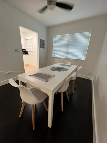 a kitchen with a refrigerator and white cabinets