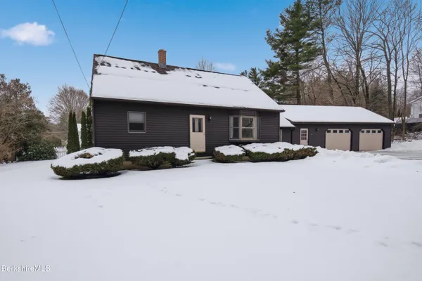 a front view of house with yard and trees