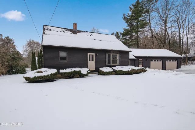 a front view of house with yard and trees