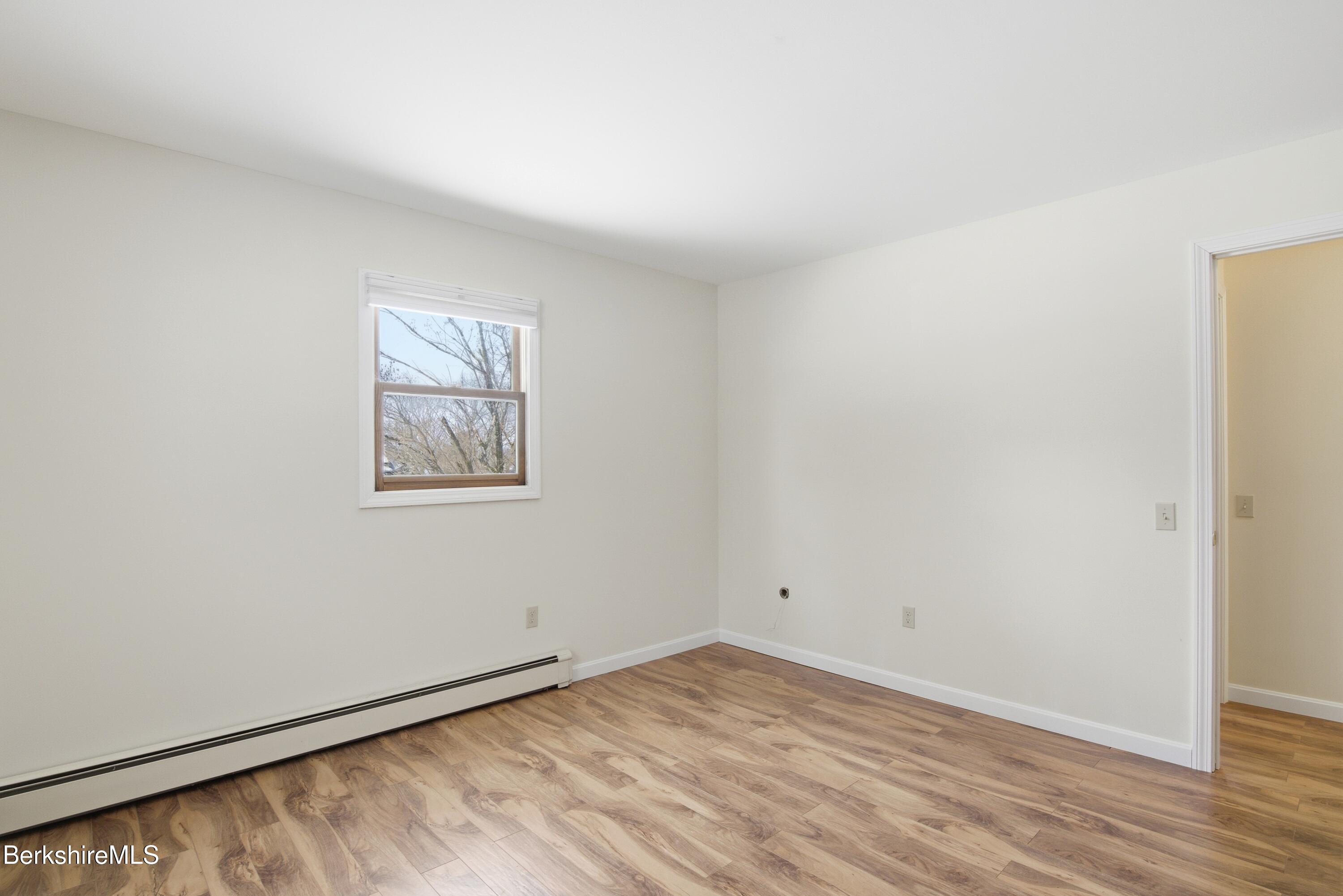 11 Opeechee Street Lanesborough, MA 01237 - Photo 32 of 35 an empty room with wooden floor and windows