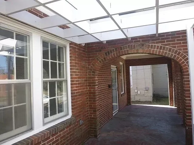 a view of a brick house with a large window