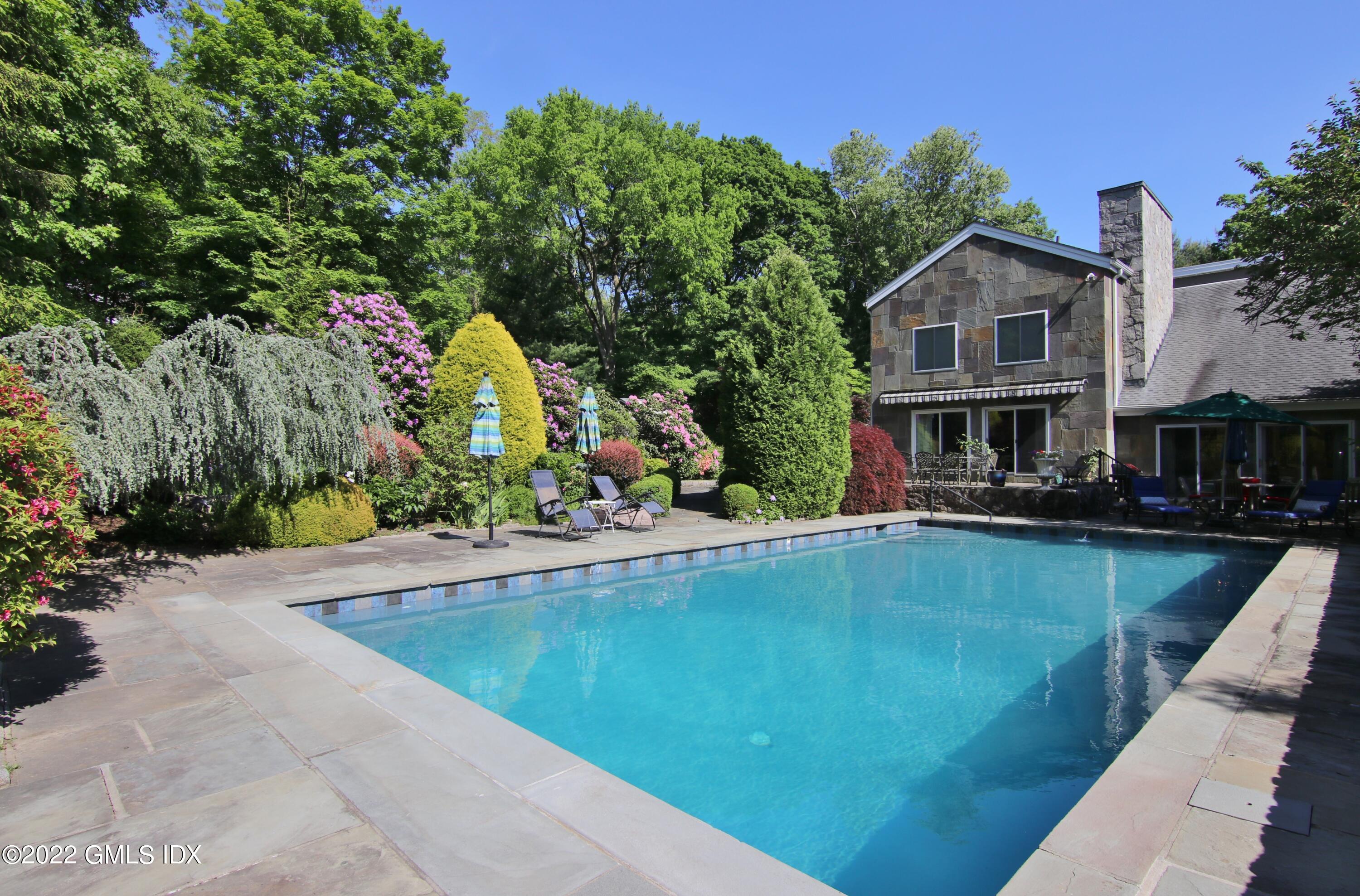 929 Riverbank Road Stamford, CT 06903 - Photo 35 of 42 Pool, patio and landscaped privacy