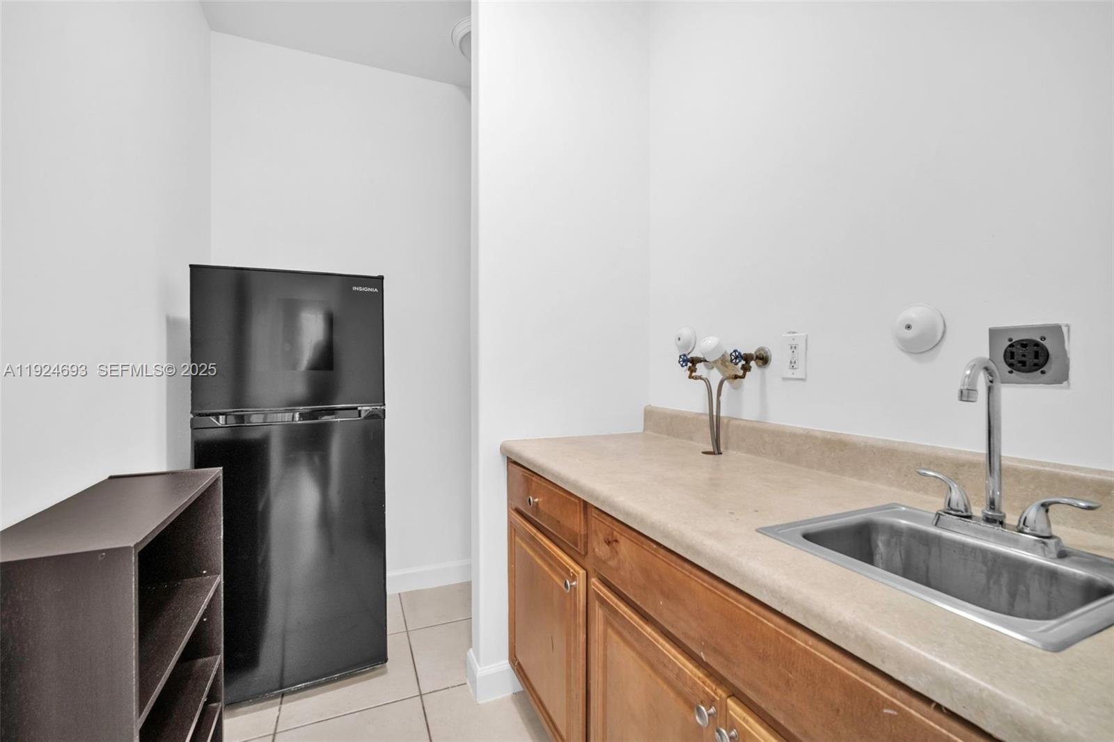 13030 Northwest 8th Street Miami, FL 33182 - Photo 13 of 54 a kitchen with a sink and refrigerator