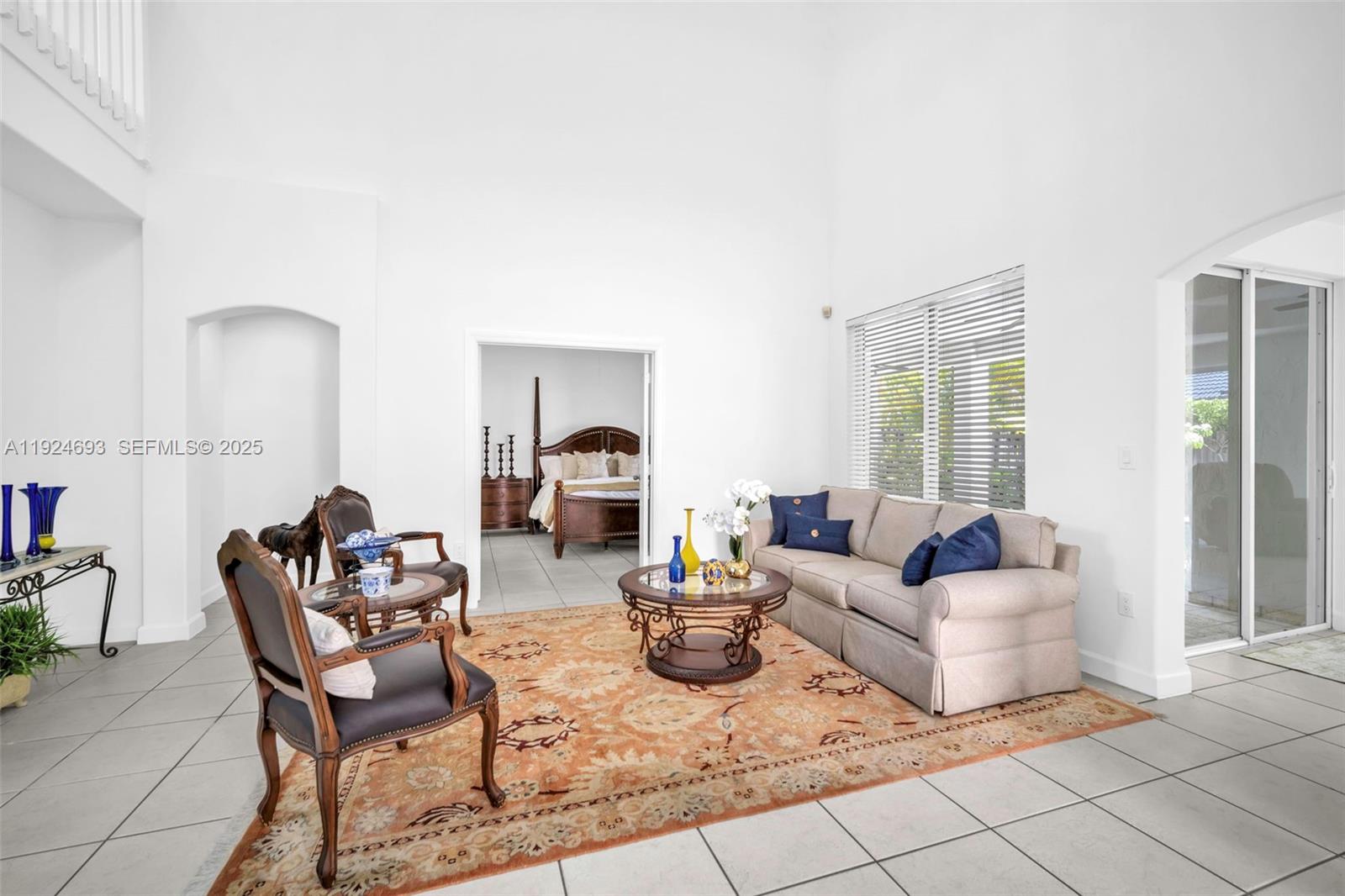 13030 Northwest 8th Street Miami, FL 33182 - Photo 16 of 54 a living room with furniture a flat screen tv and a large window