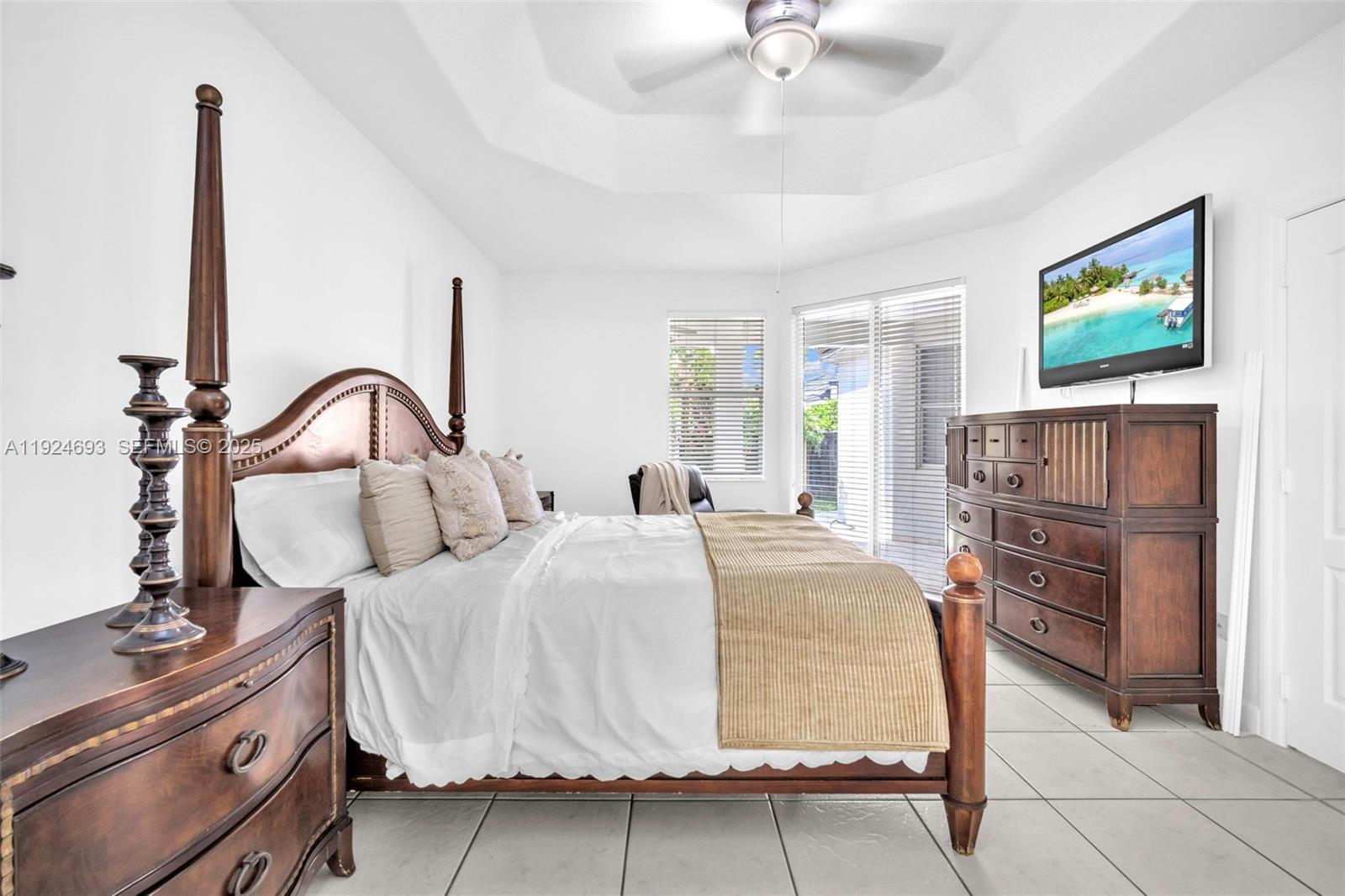 13030 Northwest 8th Street Miami, FL 33182 - Photo 20 of 54 a bedroom with a bed and a flat screen tv