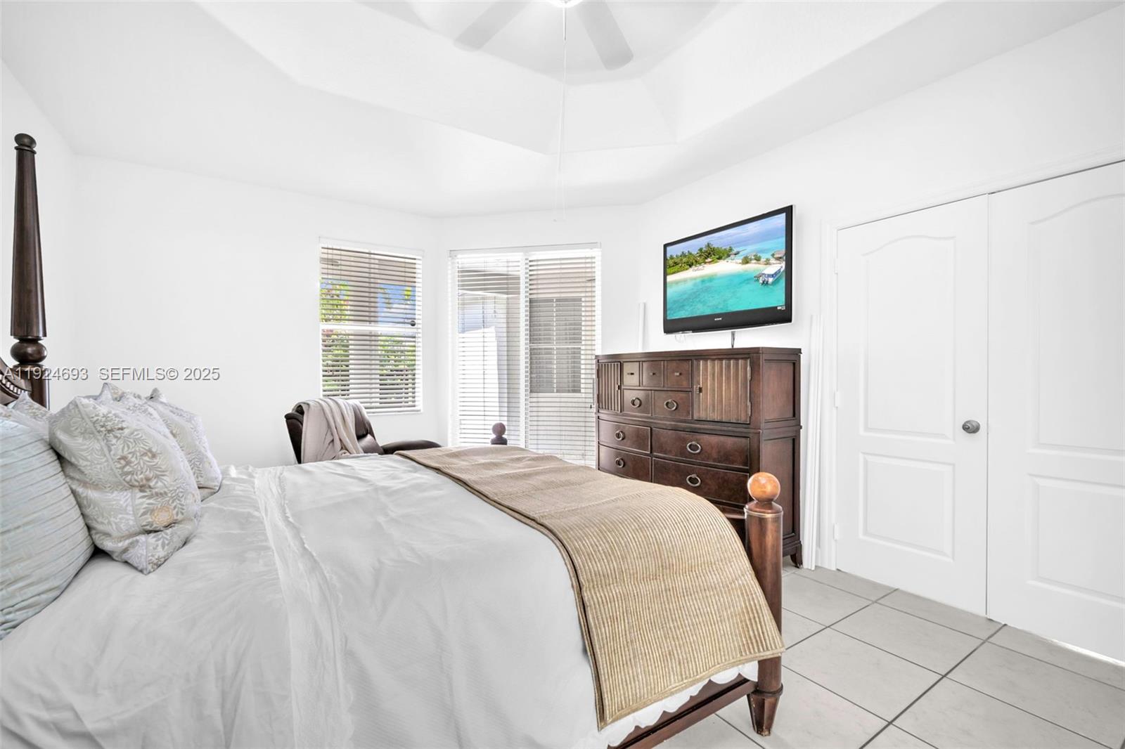 13030 Northwest 8th Street Miami, FL 33182 - Photo 21 of 54 a bedroom with a bed and a flat screen tv