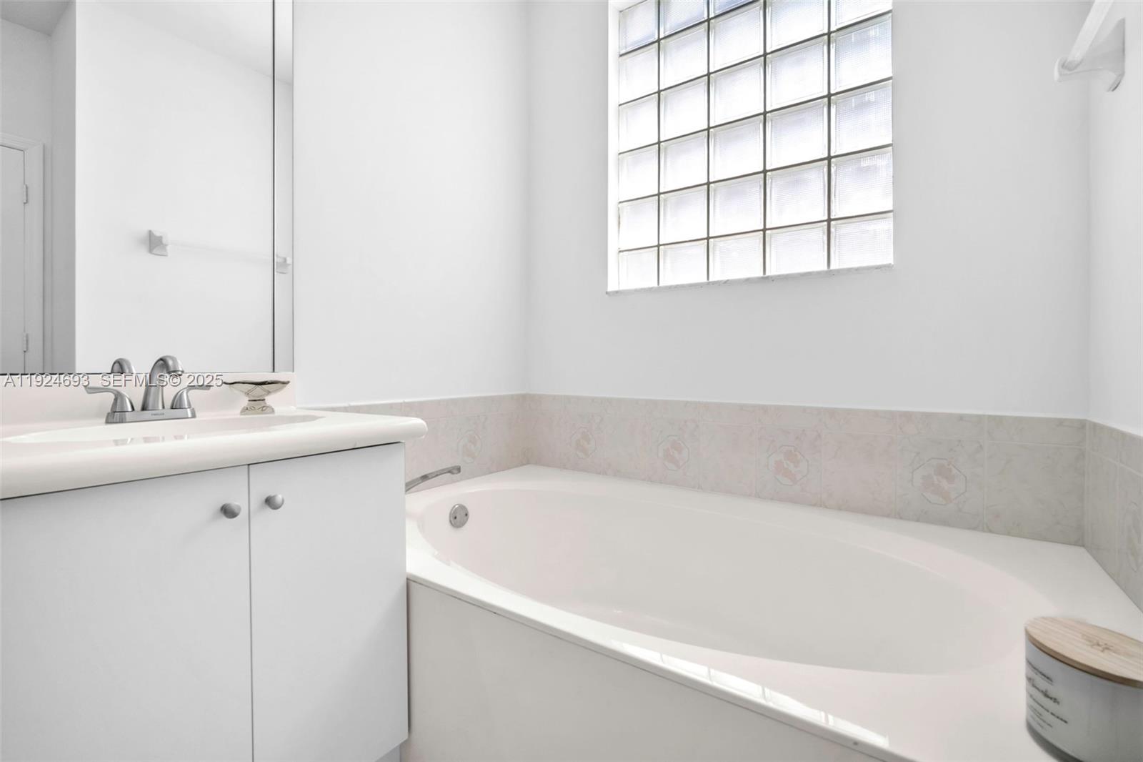 13030 Northwest 8th Street Miami, FL 33182 - Photo 25 of 54 a bathroom with a bathtub and sink