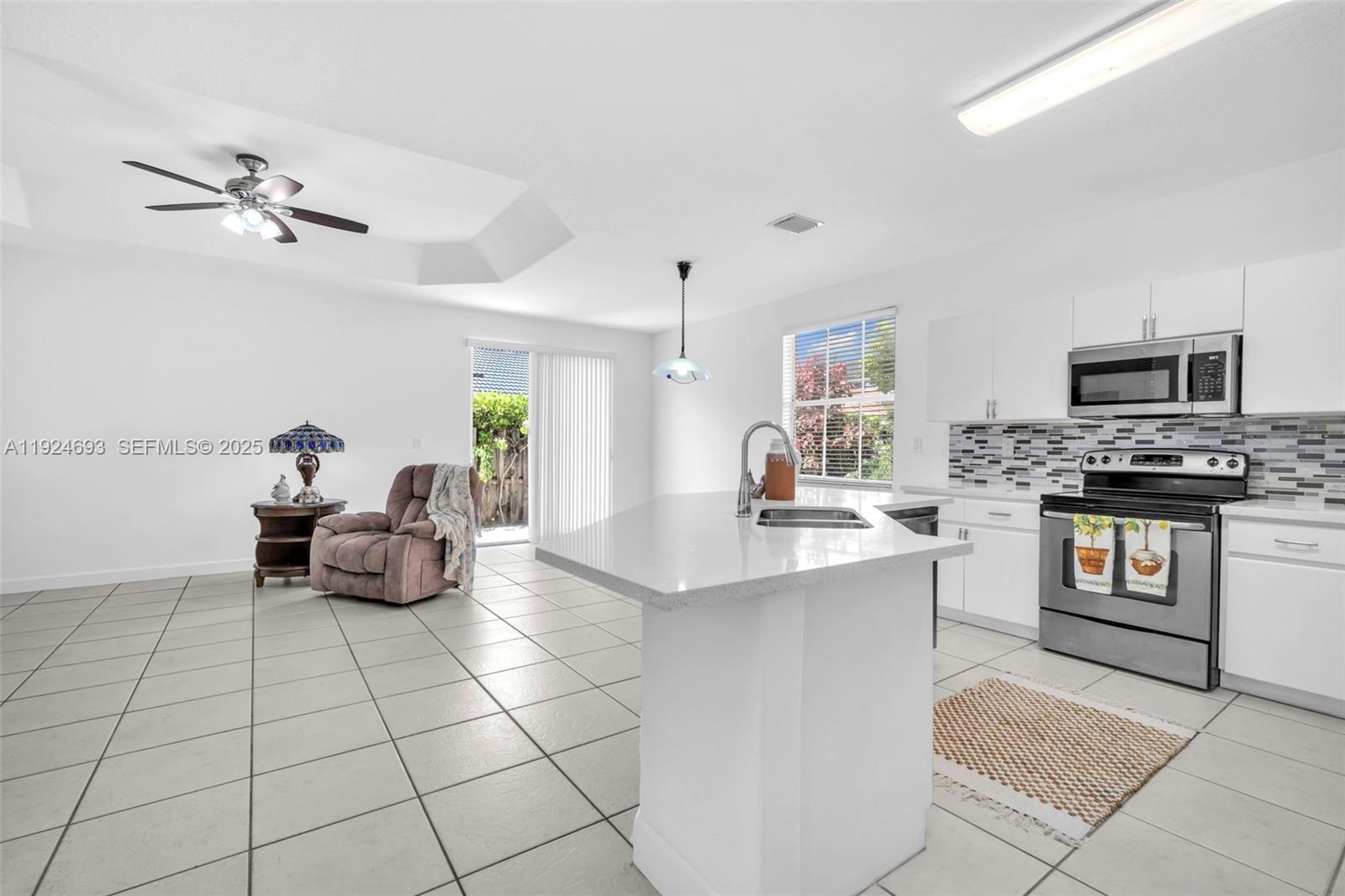 13030 Northwest 8th Street Miami, FL 33182 - Photo 26 of 54 a kitchen with counter top space appliances and cabinets