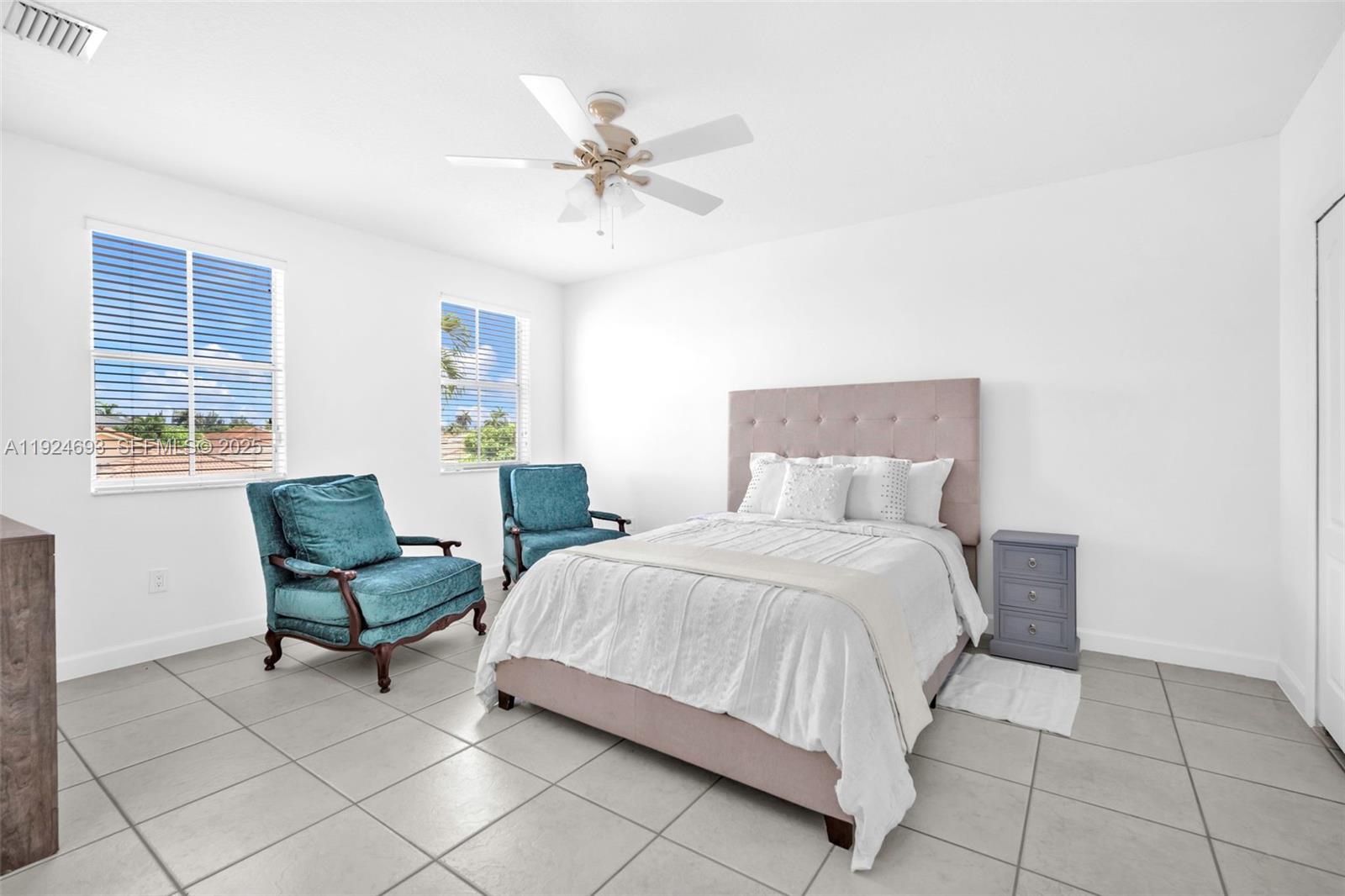 13030 Northwest 8th Street Miami, FL 33182 - Photo 36 of 54 a bedroom with a bed and chair