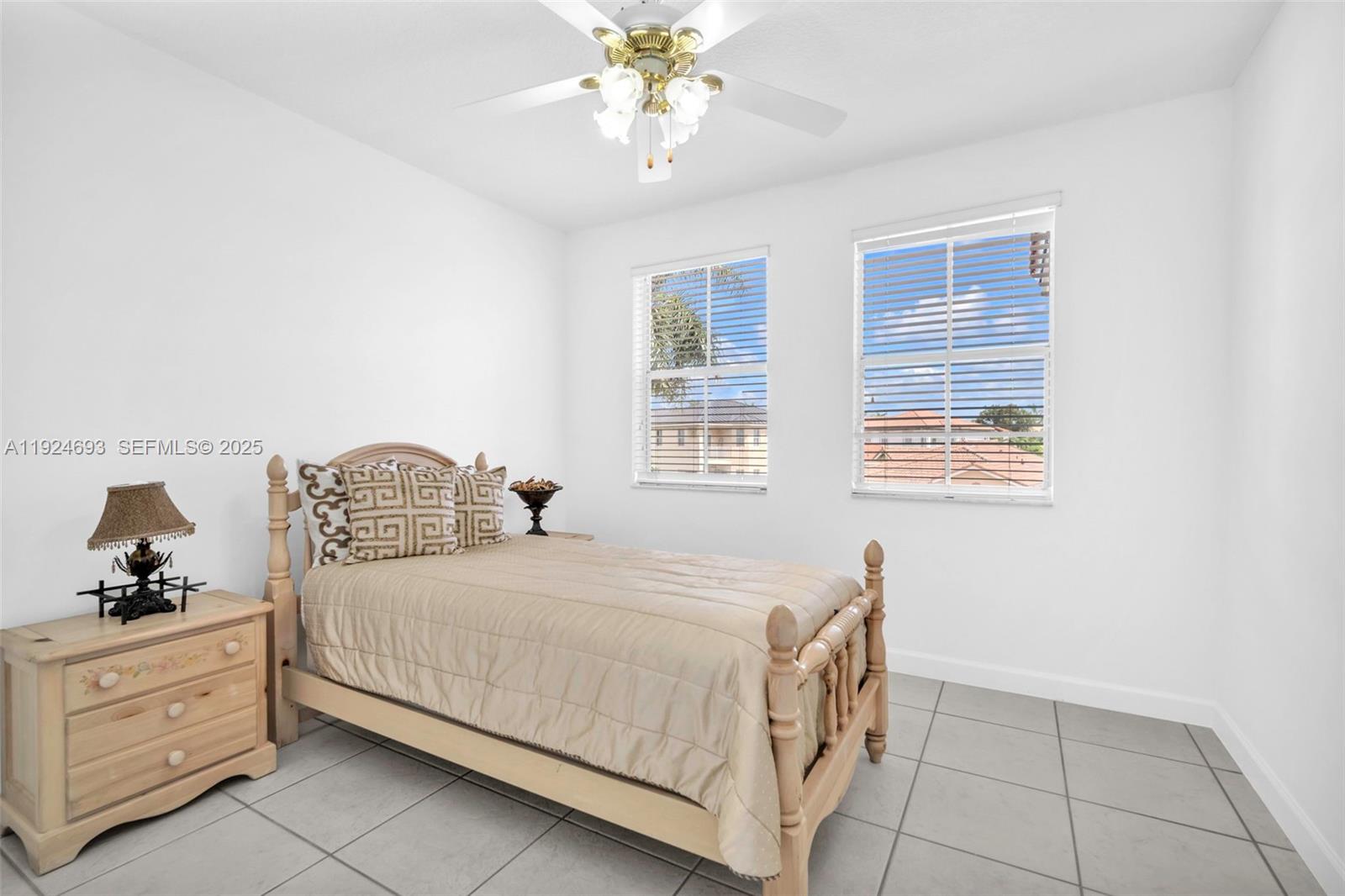 13030 Northwest 8th Street Miami, FL 33182 - Photo 40 of 54 a bedroom with a bed and a chandelier