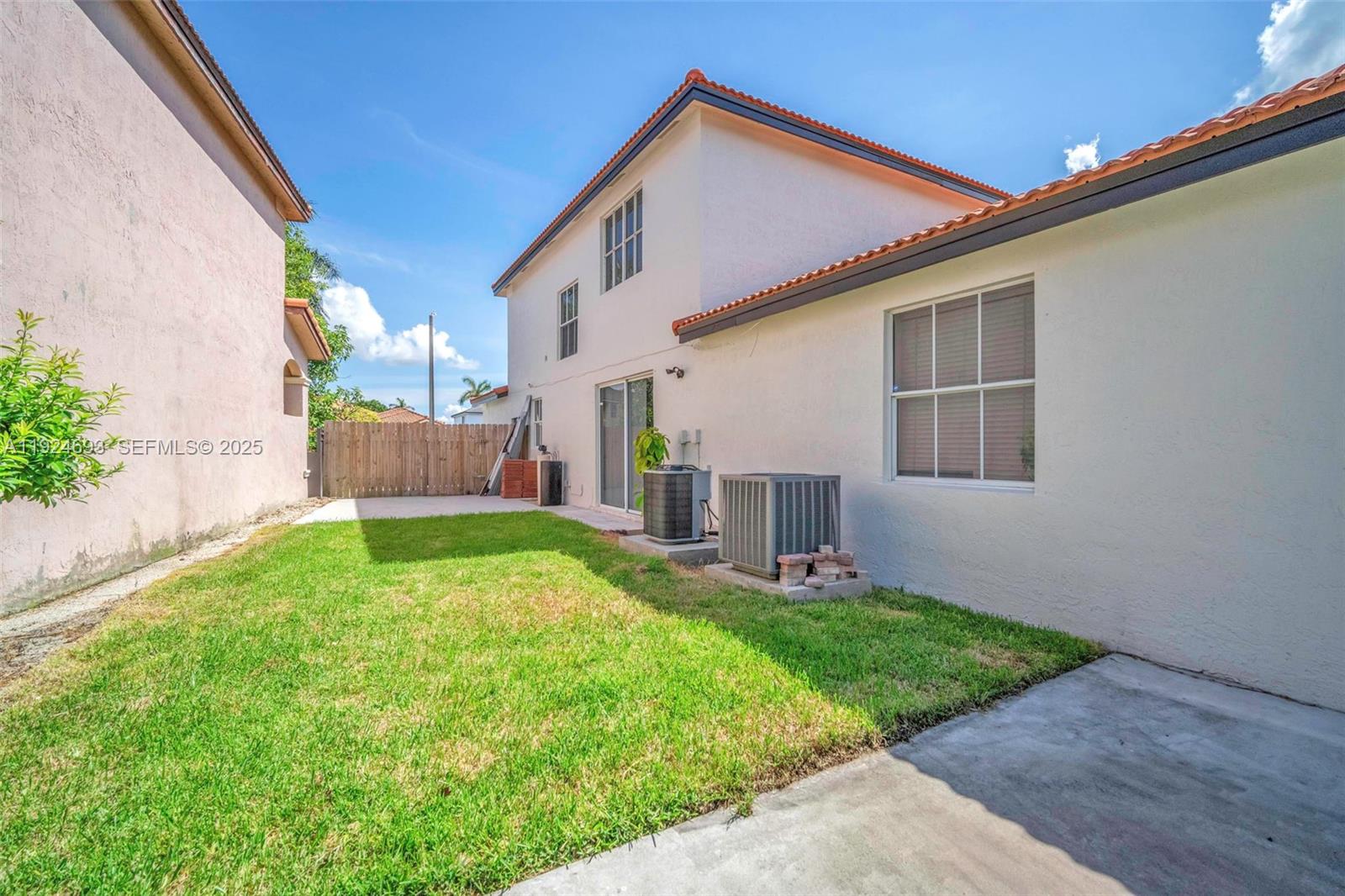 13030 Northwest 8th Street Miami, FL 33182 - Photo 7 of 54 a backyard of a house with table and chairs