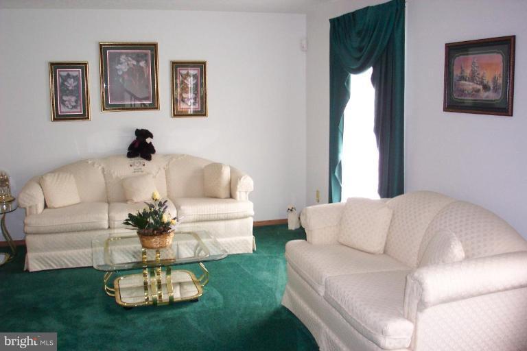 6431 St Phillips Road Linthicum Heights, MD 21090 - Photo 11 of 24 a living room with furniture couches and a dining table